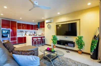 a living room with a couch and a tv at Dreambeach 2-villas in Panwa Beach
