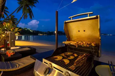 a grill on a beach with some food on it at Dreambeach 2-villas in Panwa Beach