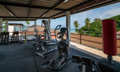 a gym with cardio equipment and a view of the ocean at Dreambeach 2-villas in Panwa Beach