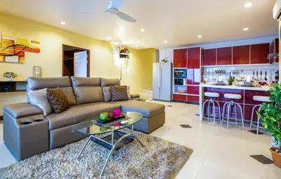 a living room with a couch and a kitchen at Dreambeach 2-villas in Panwa Beach