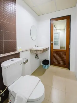 a bathroom with a toilet and a sink and a mirror at Tyler Cherngtalay in Ban Pak Lak