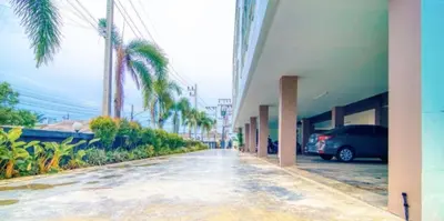 a car parked in a parking lot next to a building at Tyler Cherngtalay in Ban Pak Lak