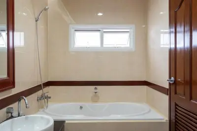 a bathroom with a tub and a sink and a window at Angel Pool Villa Phuket - SHA Extra Plus - indoor Warm pool in Phuket Town