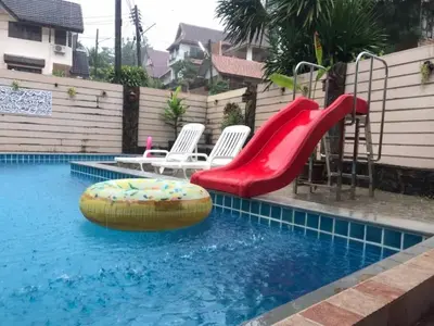 a swimming pool with a slide and a playground at Angel Pool Villa Phuket - SHA Extra Plus - indoor Warm pool in Phuket Town
