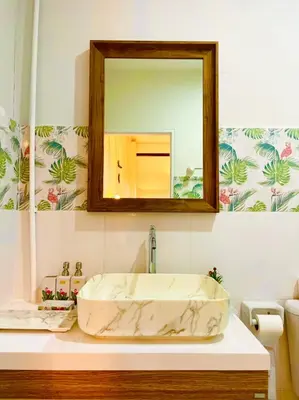 a bathroom with a marble sink and a mirror at Primego Boutique Hotel in Phuket Town