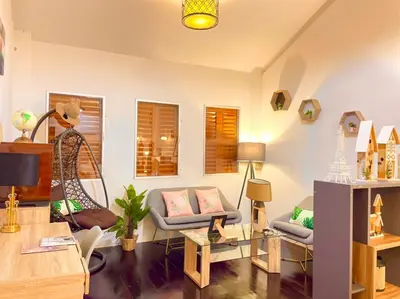 a living room with a couch and a table at Primego Boutique Hotel in Phuket Town