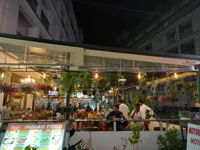 a restaurant with people sitting at tables at night at Garden Phuket Hotel in Patong Beach