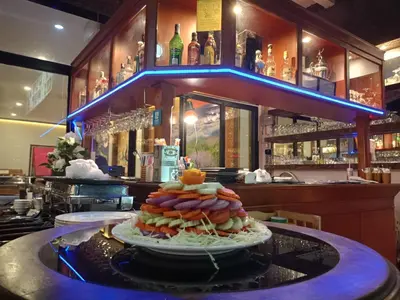 a plate of food on a counter in a bar at Garden Phuket Hotel in Patong Beach