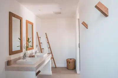 a bathroom with two sinks and a mirror at The Mooring Resort in Panwa Beach