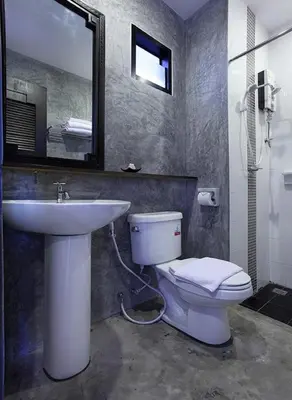 a bathroom with a sink and a toilet and a mirror at KARON SINO House in Karon Beach