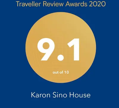 a yellow circle with the number nine and the text travel review rewards at KARON SINO House in Karon Beach