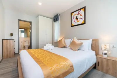 a bedroom with a large bed in a room at The Apartment at The Title Residencies Naiyang Beach in Phuket Town