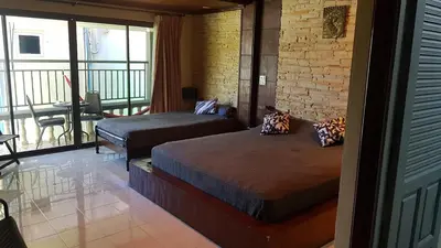 a bedroom with two beds and a balcony at Kata Happy Place in Kata Beach