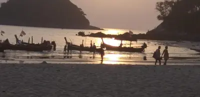 a group of people standing on a beach with boats at Kata Happy Place in Kata Beach