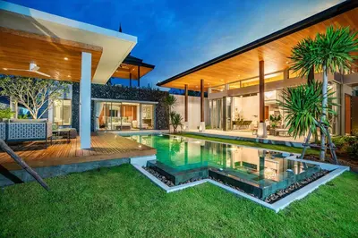 a swimming pool in the backyard of a house at Botanica Bangtao Beach Villa in Phuket Town