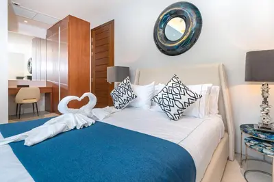 a bedroom with a bed with a swan decoration on it at Botanica Bangtao Beach Villa in Phuket Town