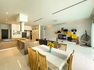 a kitchen and dining room with a table and chairs at Fantastic SeaView 4br Private Pool Villa in Rawai Beach
