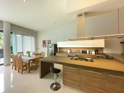 a kitchen and dining room with a table and chairs at Fantastic SeaView 4br Private Pool Villa in Rawai Beach