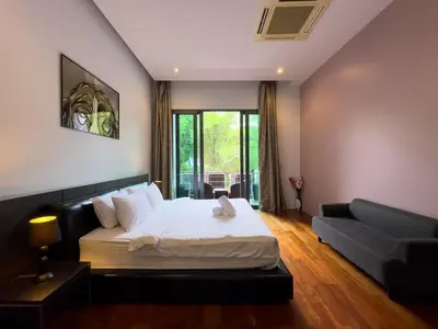 a bedroom with a large bed and a couch at Fantastic SeaView 4br Private Pool Villa in Rawai Beach