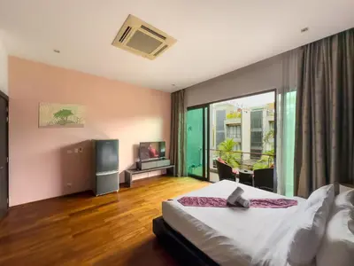 a bedroom with a large bed and a television at Fantastic SeaView 4br Private Pool Villa in Rawai Beach