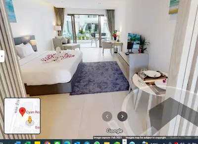 a bedroom with a bed and a living room at CYAN Resort Kamala Beach Apartments Condominiums in Kamala Beach