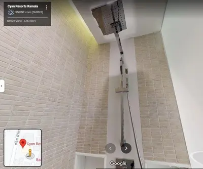 a shower in a bathroom with a brick wall at CYAN Resort Kamala Beach Apartments Condominiums in Kamala Beach