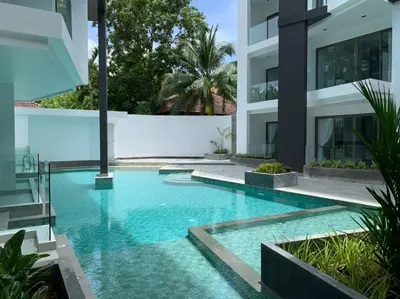 a swimming pool in the middle of a building at CYAN Resort Kamala Beach Apartments Condominiums in Kamala Beach