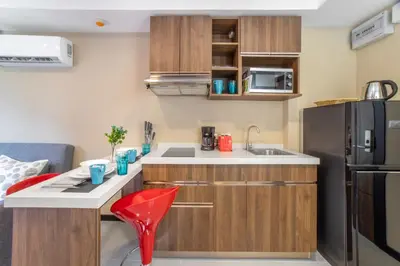 a small kitchen with a sink and a refrigerator at LUMA Condo 1BR Open View NBC Nai Harn in Rawai Beach