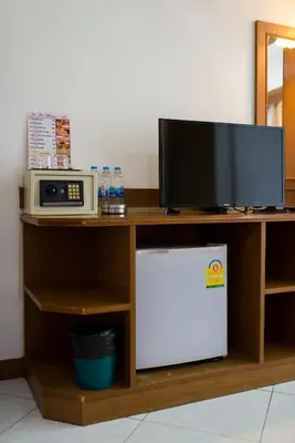 a desk with a microwave and a television on it at Magnific Patong in Patong Beach