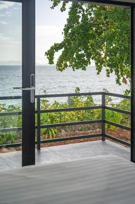 a view of the ocean from a balcony at Pine Bungalow Krabi in Klong Muang Beach