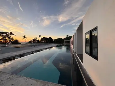 a swimming pool on the side of a building at Pine Bungalow Krabi in Klong Muang Beach