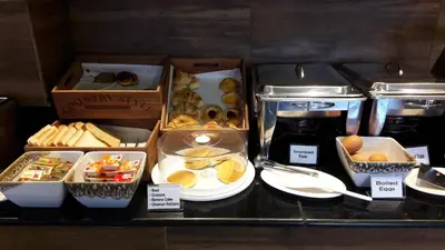 a counter with boxes of different types of food at Patong Mansion - SHA Certified in Patong Beach