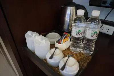 a drawer with two bottles of water and toiletries at Patong Mansion - SHA Certified in Patong Beach
