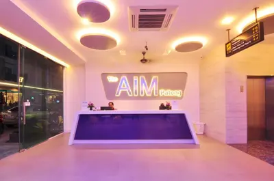 an amm reflecting sign on the wall of a building at The AIM Patong Hotel in Patong Beach