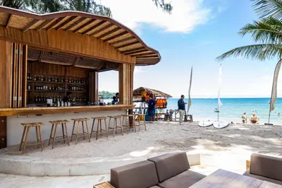a bar on the beach with a view of the ocean at Arinara Beach Resort Phuket - SHA Extra Plus in Bang Tao Beach