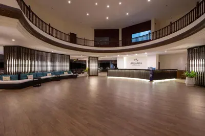 an empty lobby with a stage in the middle of a building at Arinara Beach Resort Phuket - SHA Extra Plus in Bang Tao Beach