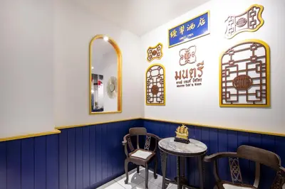 a blue and white room with a table and chairs at Montree Phuket Hotel in Phuket Town