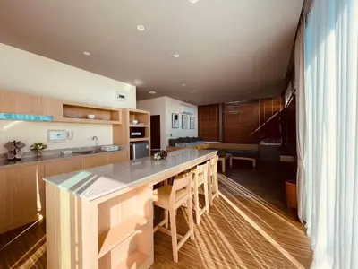 a kitchen with a large island in the middle at Charcoal Panwa Beach Phuket in Ban Tha Khreng