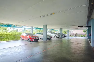 a parking lot with several cars parked in it at AJ Residence in Phuket Town