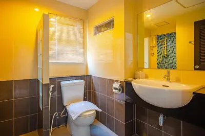 a bathroom with a white toilet and a sink at AJ Residence in Phuket Town