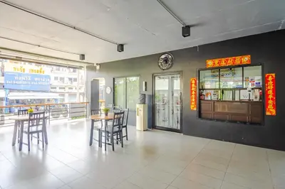 a restaurant with tables and chairs and a bar at AJ Residence in Phuket Town