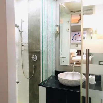 a bathroom with a sink and a shower at Kata Beach Aspasia Boutique Apartment in Kata Beach