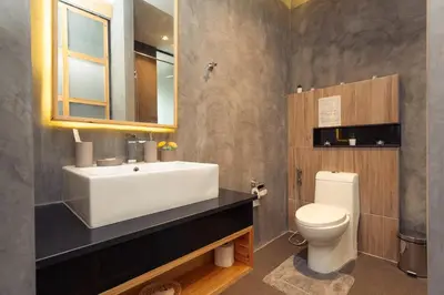 a bathroom with a white sink and a toilet at Cozy design studio near Nai Harn beach in Nai Harn Beach