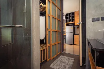 a kitchen with a hallway with a refrigerator and a door at Cozy design studio near Nai Harn beach in Nai Harn Beach