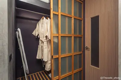 a wooden cabinet with a shirt hanging in it at Cozy design studio near Nai Harn beach in Nai Harn Beach