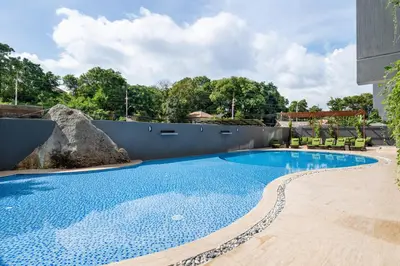 a swimming pool in the backyard of a house at Calypso Garden by Villacarte in Rawai Beach