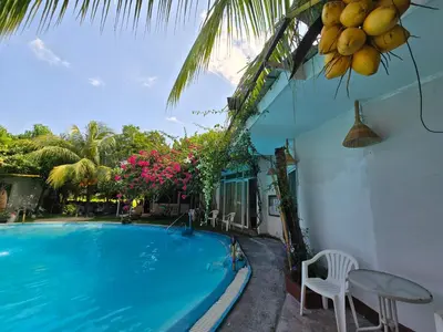 a villa with a swimming pool and a house at OASIS Phuket Airport in Nai Yang Beach