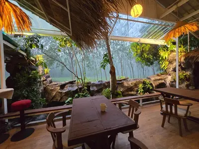 a restaurant with a table and chairs in a cave at OASIS Phuket Airport in Nai Yang Beach