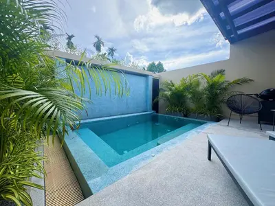 a swimming pool in the middle of a patio with plants at Beautiful 1br Plunge Pool Villa Walk To Bangtao Beach in Ban Thalat Choeng Thale