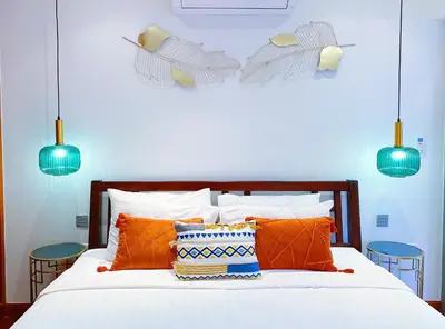 a bedroom with a bed with orange pillows and blue lights at Beautiful 1br Plunge Pool Villa Walk To Bangtao Beach in Ban Thalat Choeng Thale